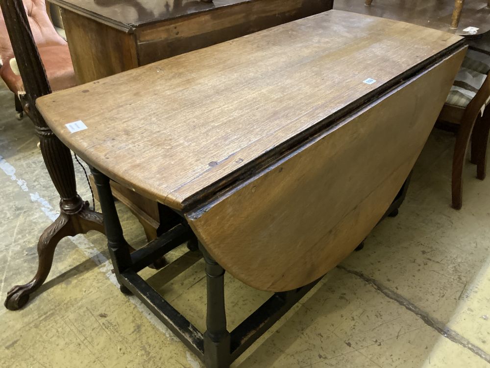 An 18th century oak gateleg dining table, width 128cm 150cm extended height 74cm